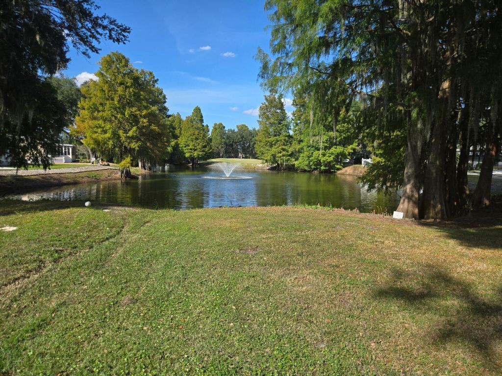 Golf course fairway with pond and trees